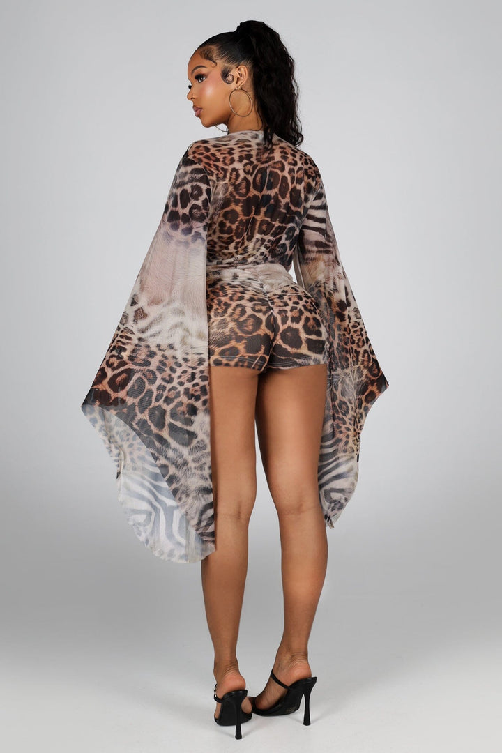 Sheer mesh long sleeve romper with deep plunging neckline featuring a mixed animal print