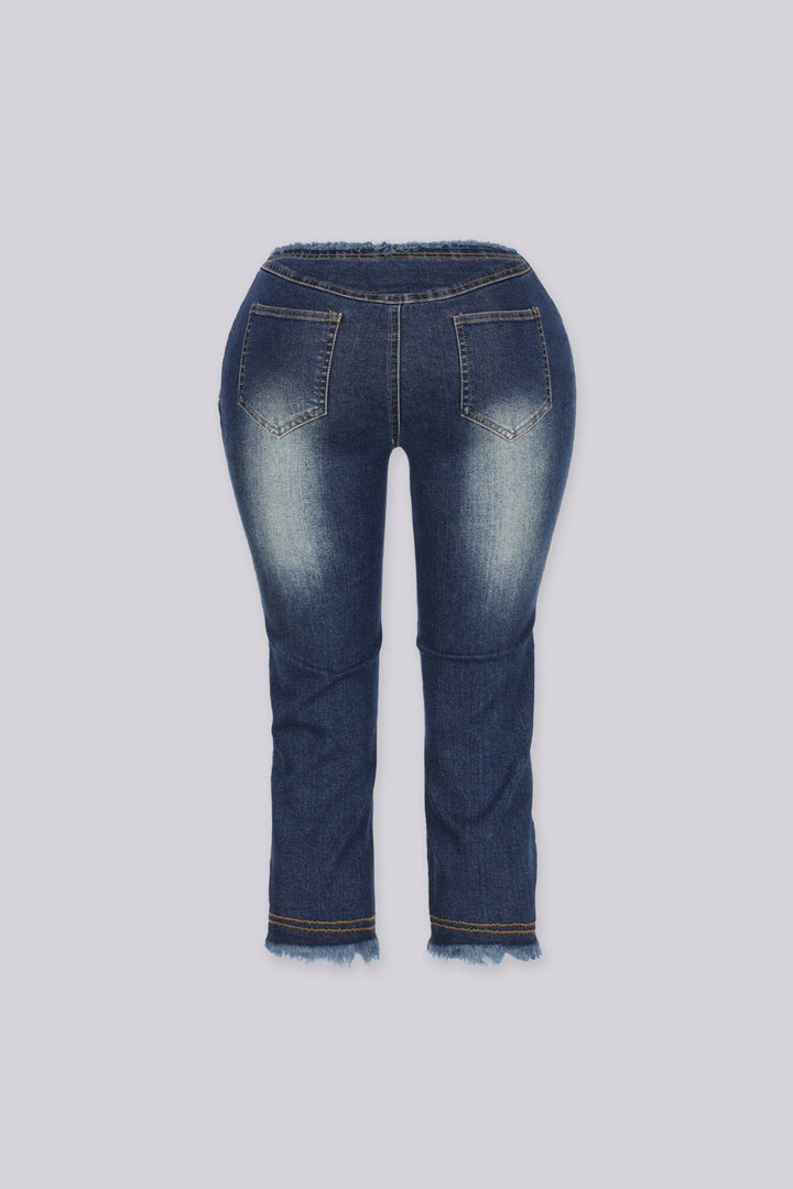 Slim fit low rise denim capri with frayed hem, Waistband dips into a deep V at the center front featuring raw edge finish