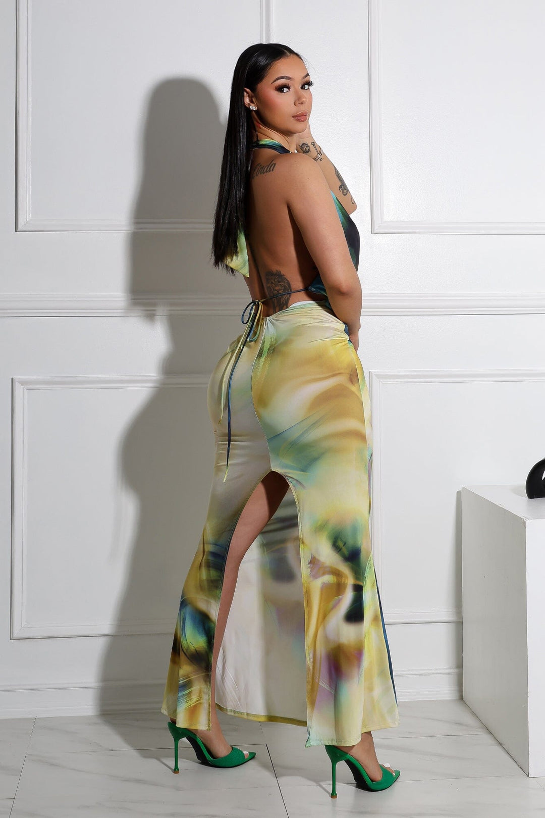 Bodycon halter maxi dress with deep plunging draped cowl neckline featuring flowing silhouette with back slit detail