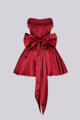 Off the shoulder fitted bodice satin mini dress with draped fold over neckline featuring dropped waistline and layers of full tiered ruffle skirt