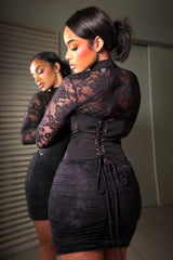 black lace long sleeve mini dress with a corset style back dress features sheer floral lace sleeves and a ruched laced up back detail