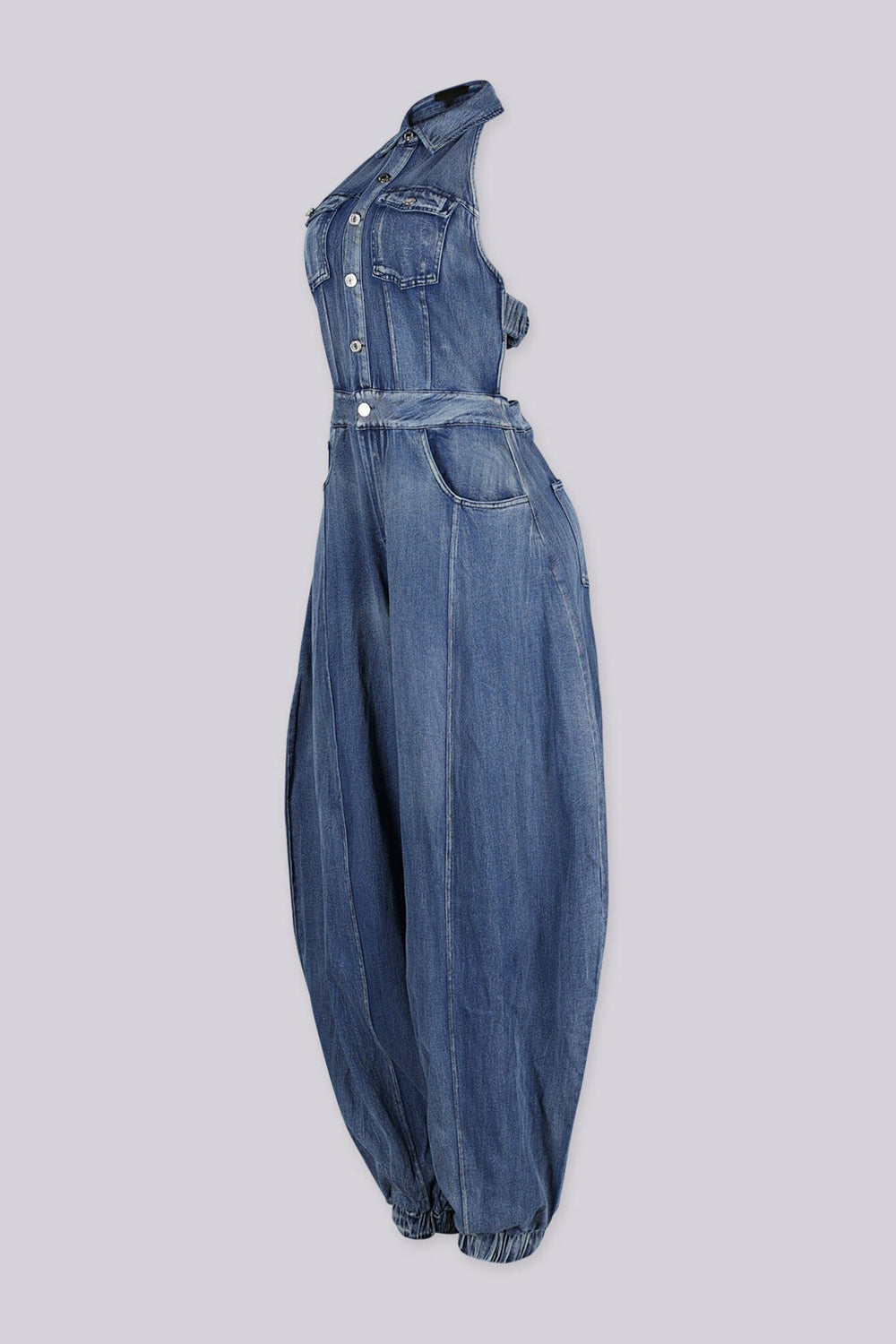 Halter bodice denim jumpsuit with elastic cuffs finish the ankles, side view