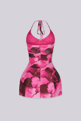 Halter mini dress with a plunging scooped neckline
Layered ruffle detailing along the neckline and cascades down the center front bust and bodice