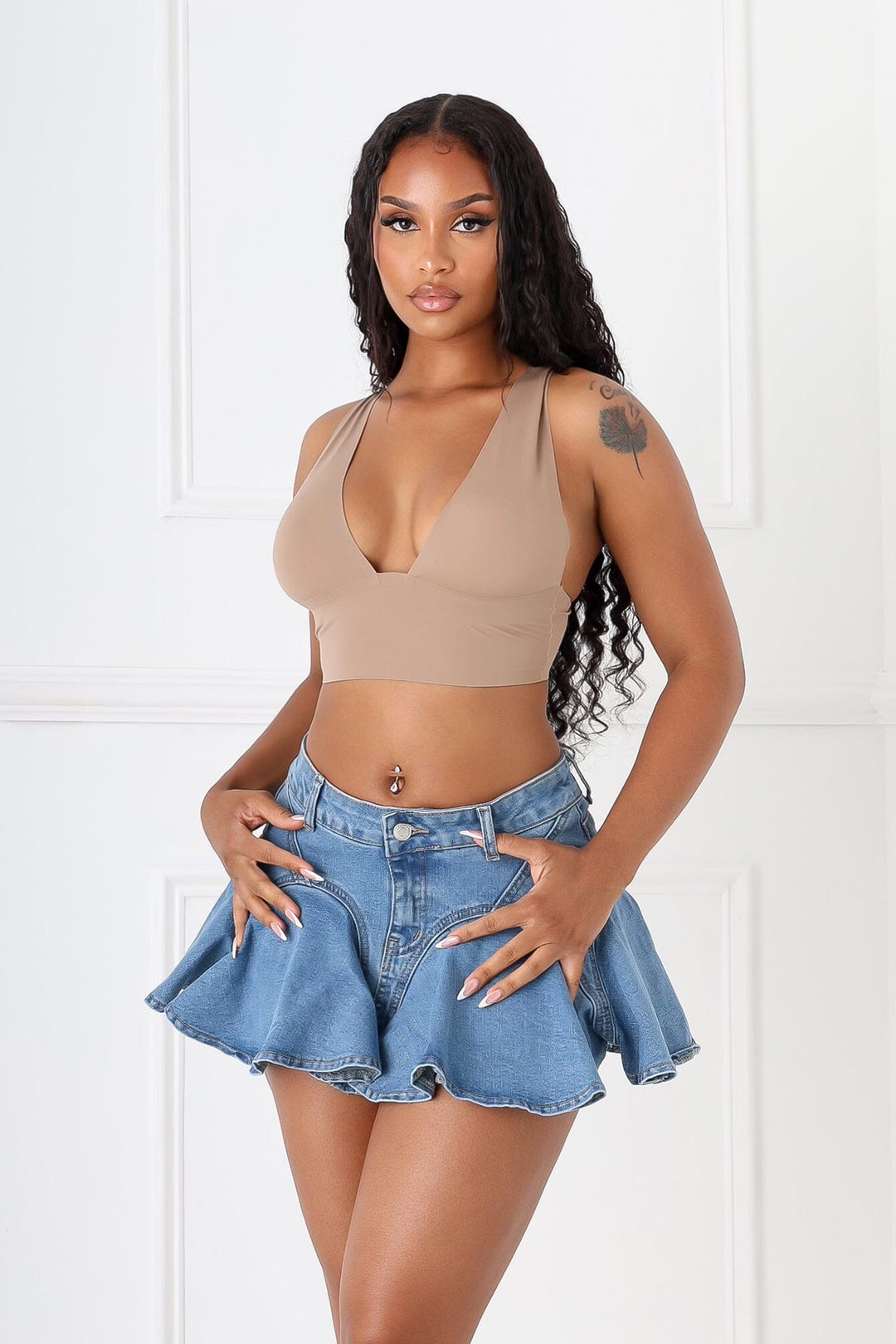 High waisted A line denim skirt featuring flounce hem and front zip fastening