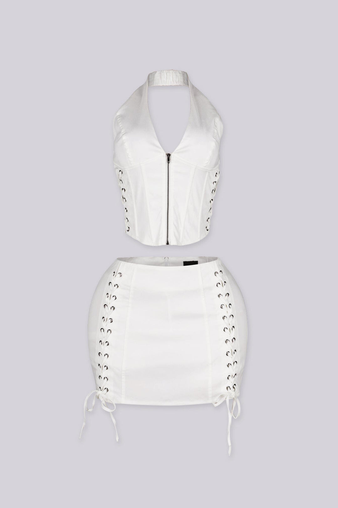 Cropped halter top with lace up panel at the sides featuring metal zipper closure at center front
Paired with a matching mini skirt with lace up panel at the sides