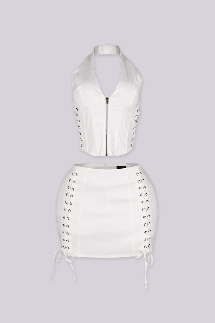 Cropped halter top with lace up panel at the sides featuring metal zipper closure at center front
Paired with a matching mini skirt with lace up panel at the sides
