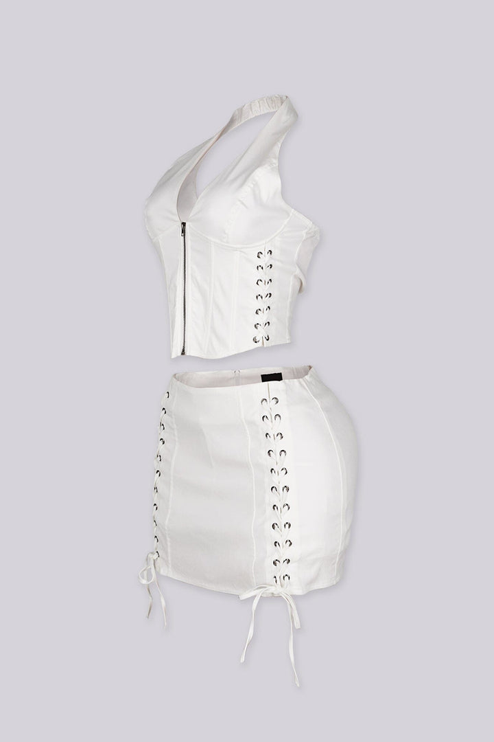 Cropped halter top with lace up panel at the sides featuring metal zipper closure at center front
Paired with a matching mini skirt with lace up panel at the sides