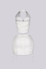Cropped halter top with lace up panel at the sides featuring metal zipper closure at center front
Paired with a matching mini skirt with lace up panel at the sides