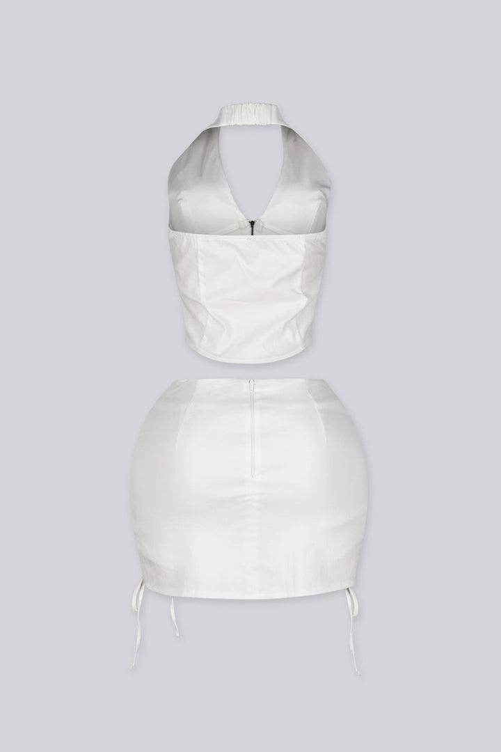 Cropped halter top with lace up panel at the sides featuring metal zipper closure at center front
Paired with a matching mini skirt with lace up panel at the sides