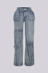 High-waisted wide leg medium wash jeans featuring stud-lined front pockets and dangling straps with silver O-ring hardware