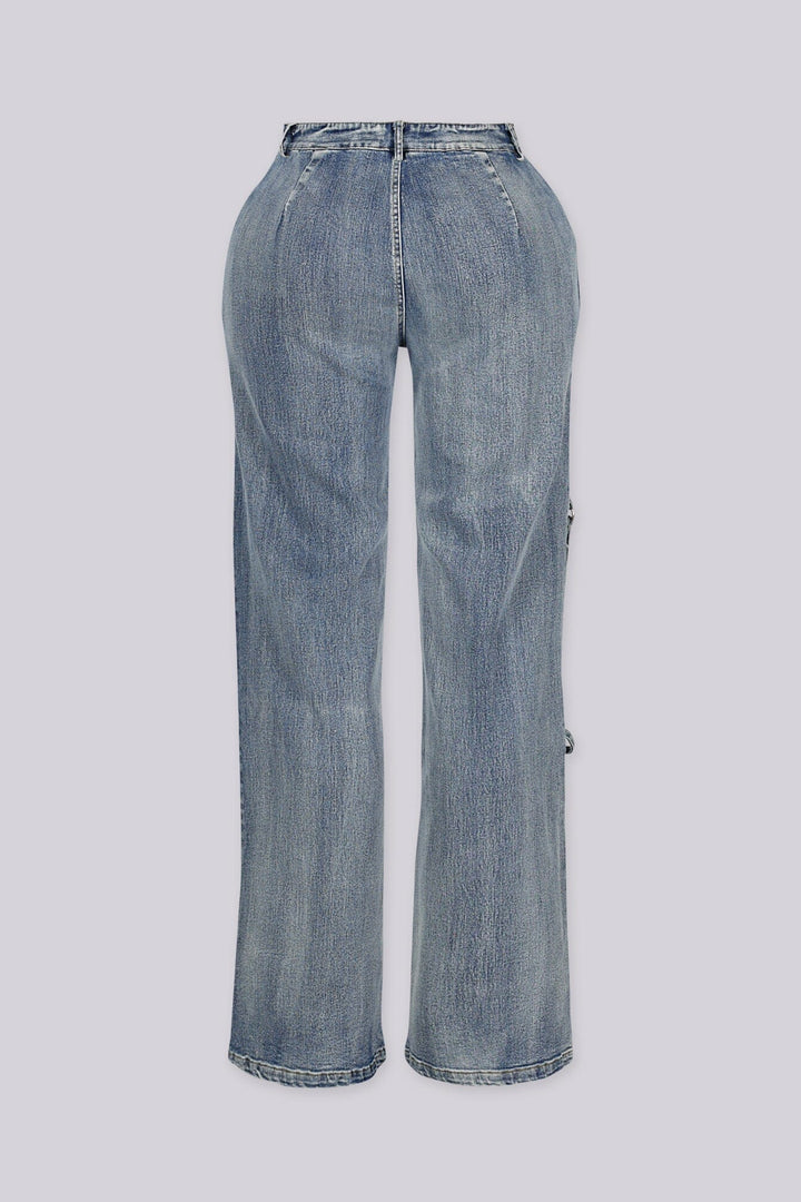 High-waisted wide leg medium wash jeans featuring stud-lined front pockets and dangling straps with silver O-ring hardware