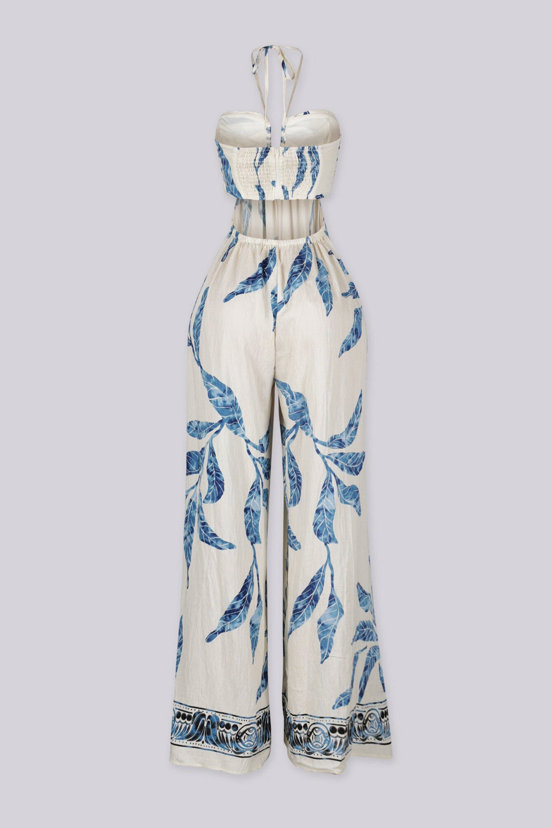 Blue leaf print wide leg halter jumpsuit featuring gathered center bust detail with deep plunge notch
Side waist cut out with smocked back detail