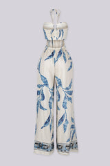 Blue leaf print wide leg halter jumpsuit featuring gathered center bust detail with deep plunge notch
Side waist cut out with smocked back detail