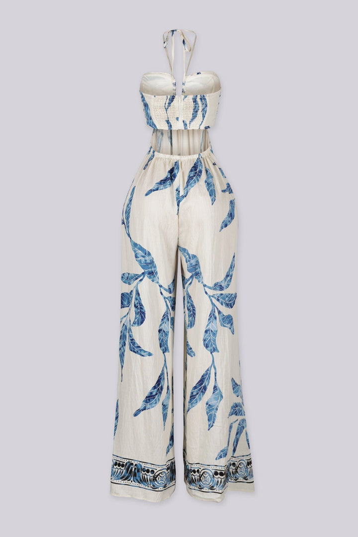Blue leaf print wide leg halter jumpsuit featuring gathered center bust detail with deep plunge notch
Side waist cut out with smocked back detail