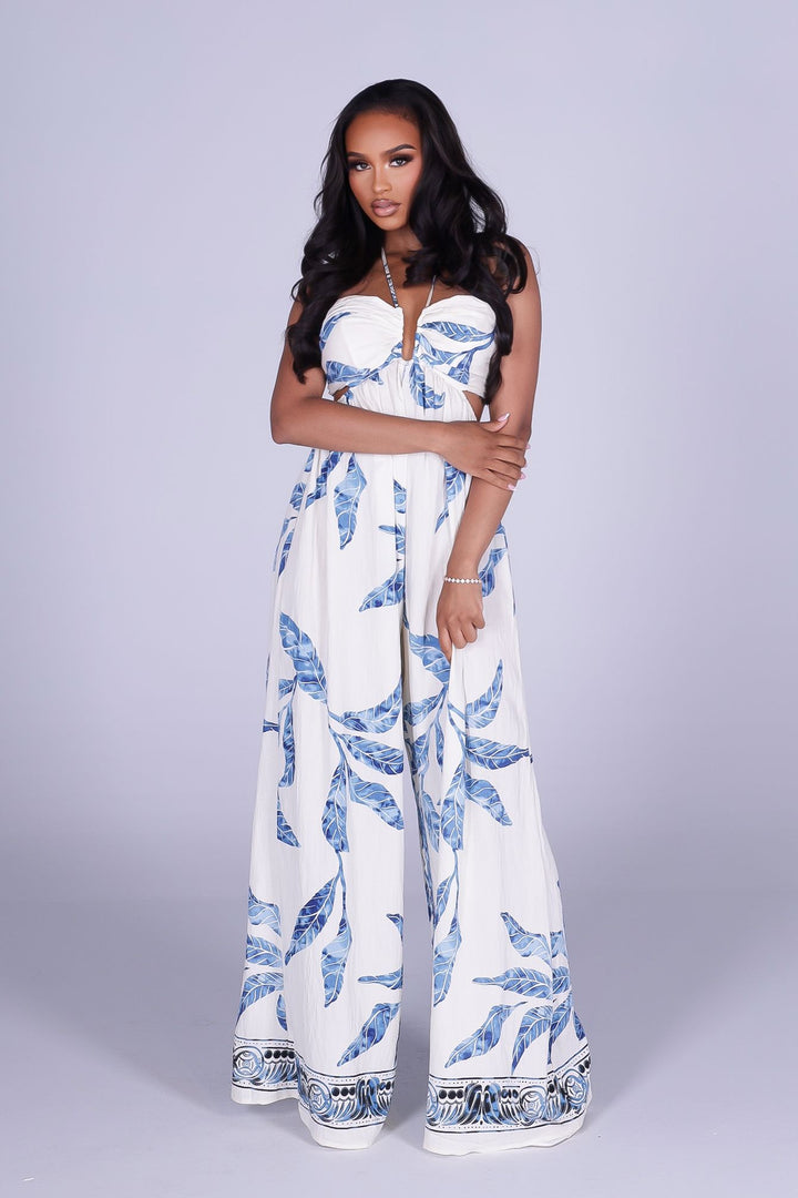 Blue leaf print wide leg halter jumpsuit featuring gathered center bust detail with deep plunge notch
Side waist cut out with smocked back detail