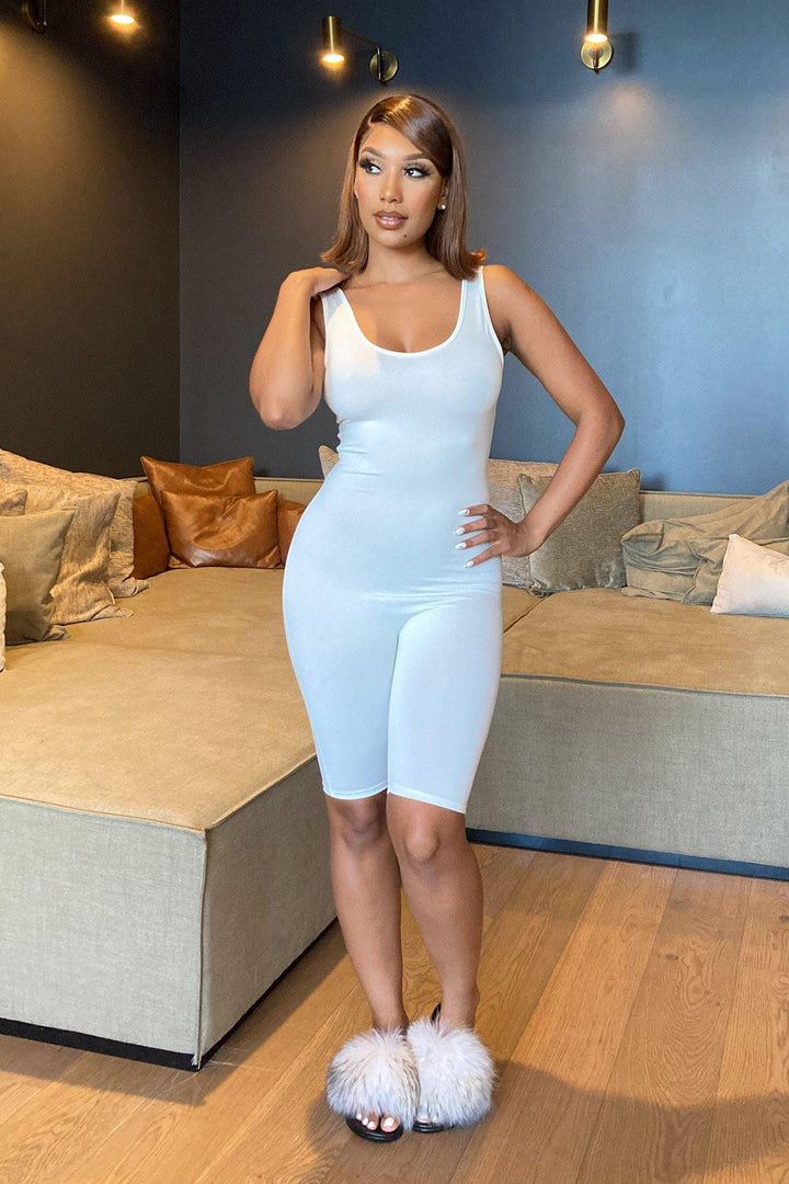One-piece romper with a fitted tank top design, scoop neckline, and racerback-style straps