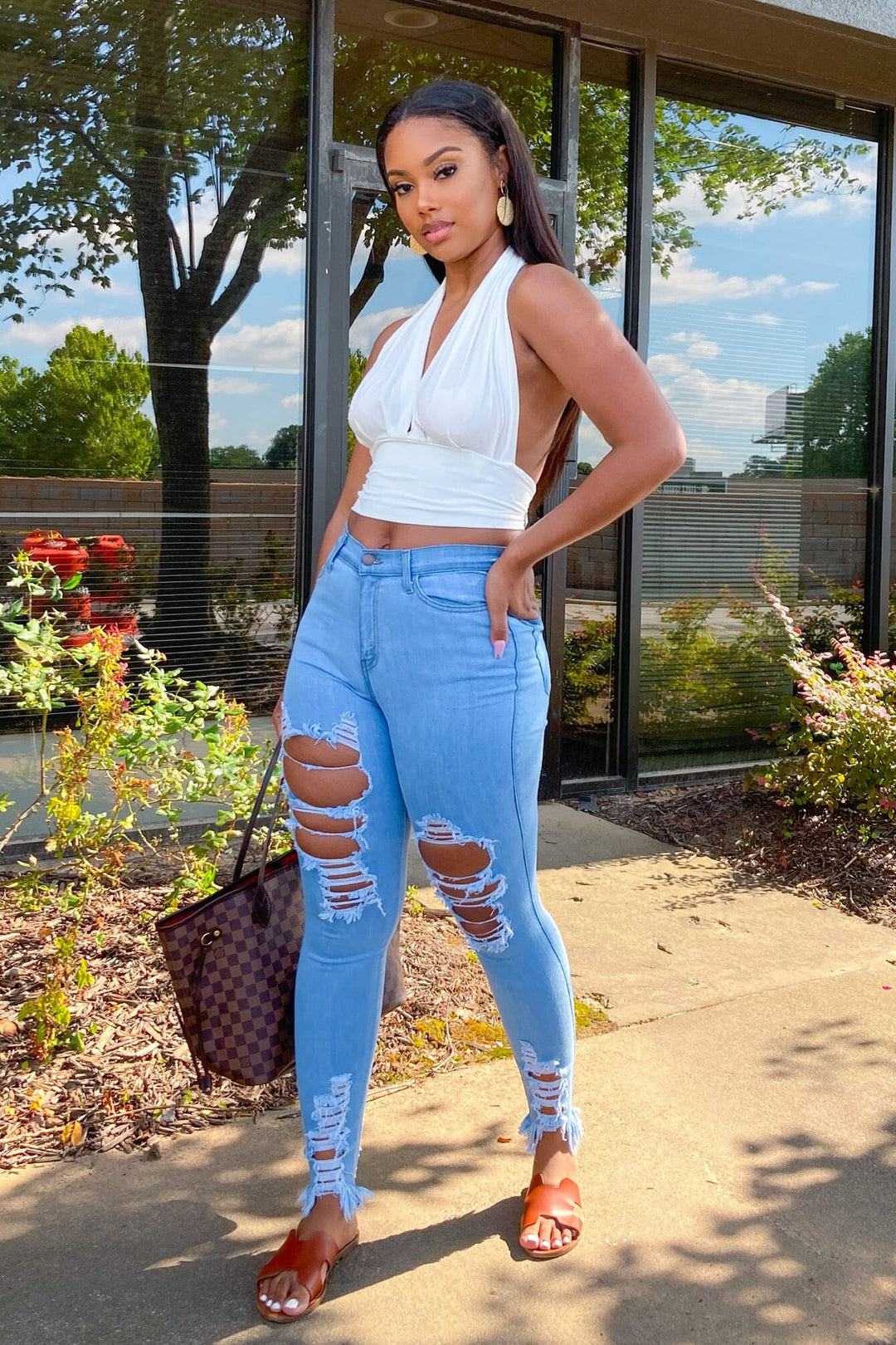 High waisted denim jeans with destroyed detail with frayed hem line