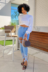 High waisted denim jeans with destroyed detail with frayed hem line