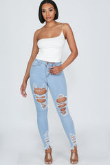 High waisted denim jeans with destroyed detail with frayed hem line