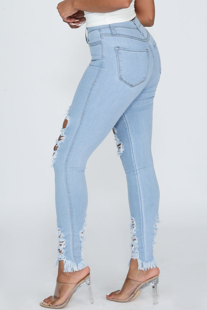 High waisted denim jeans with destroyed detail with frayed hem line