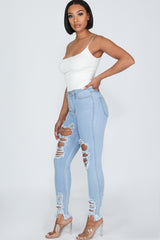 High waisted denim jeans with destroyed detail with frayed hem line