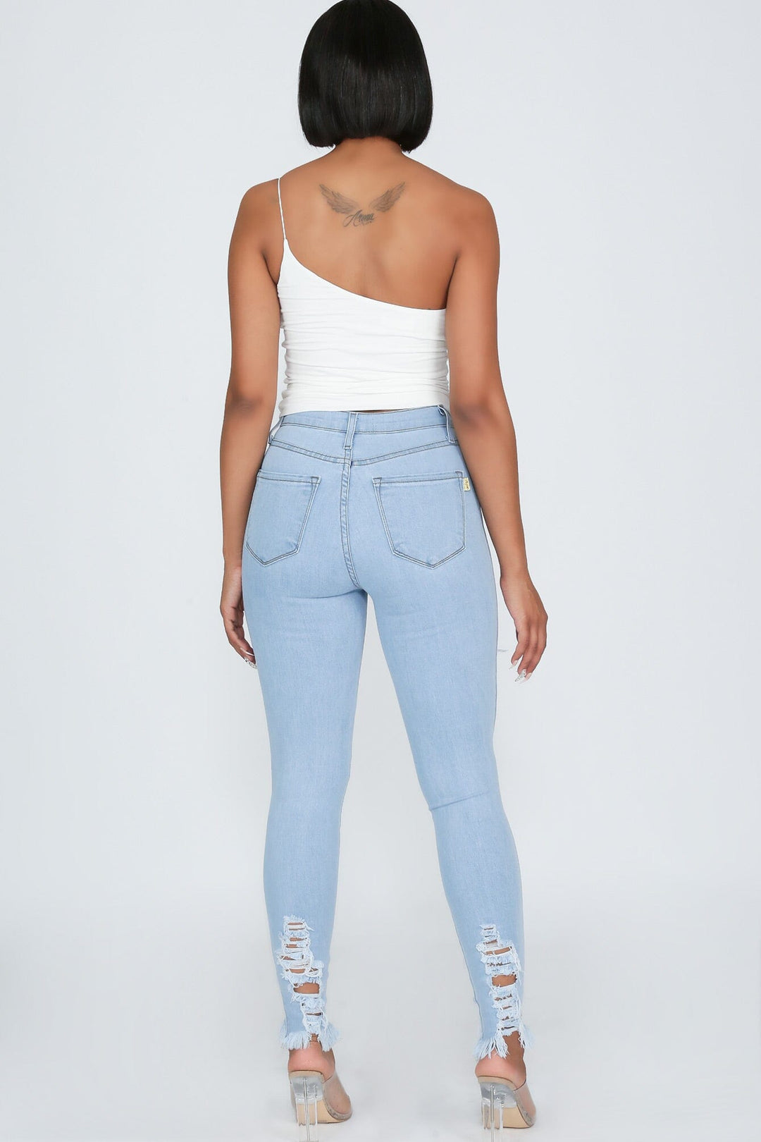 High waisted denim jeans with destroyed detail with frayed hem line