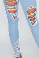 High waisted denim jeans with destroyed detail with frayed hem line